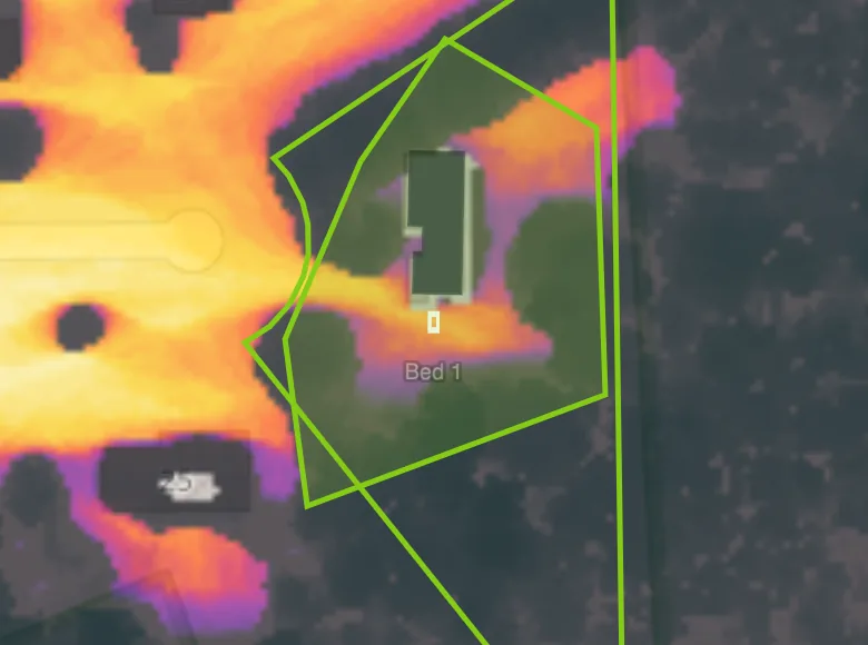 A satellite photo of a real parcel over its measured sun map, with the reader's own hand-traced felling outline drawn across it — the canopy inside the outline still shading the ground, before any edit